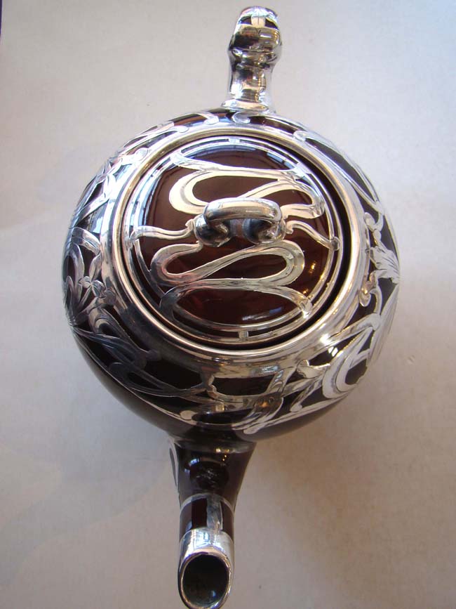 An absolutely stunning scarlet red ceramic teapot with unbelievable silver overlay circa 1890 — image 5